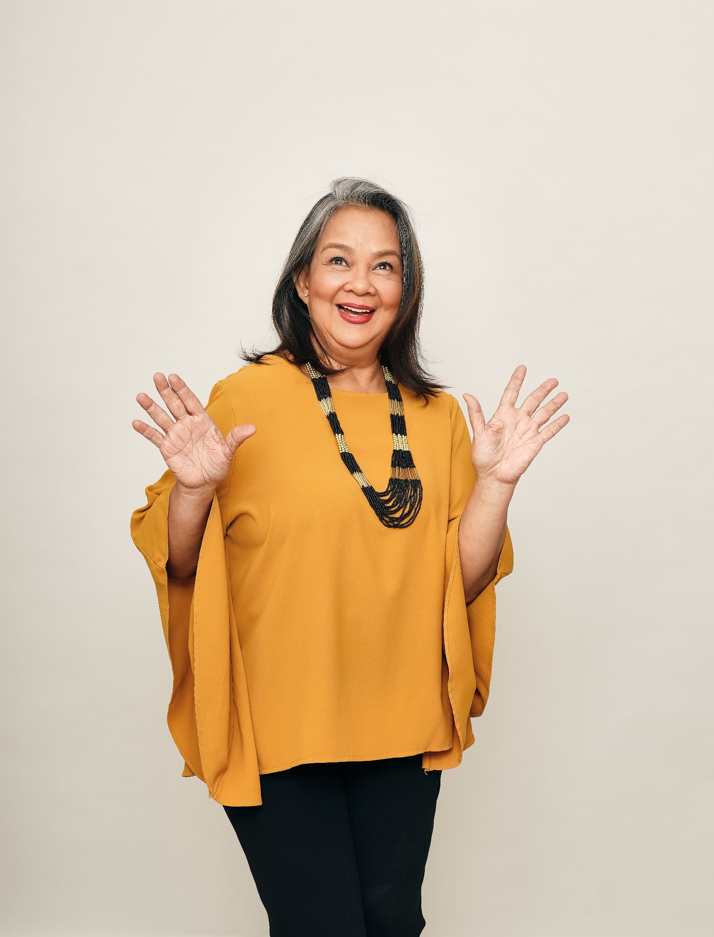 Malou De Guzman, workshop leader of Acting Workshop PH, smiling with both hands raised